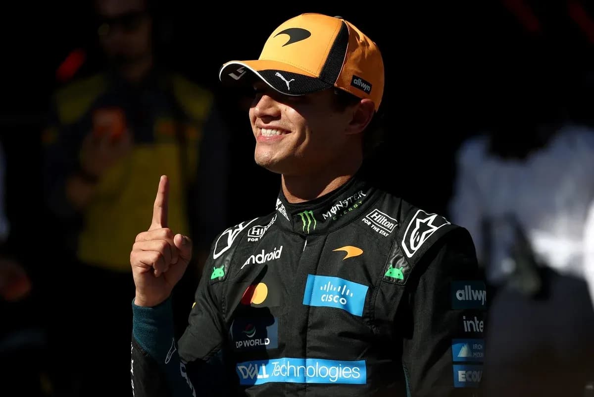 Driver celebrating with finger raised in pit area