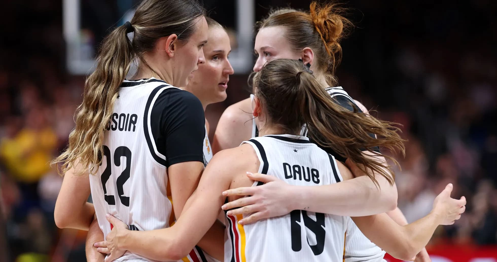 Players celebrating in a huddle during game