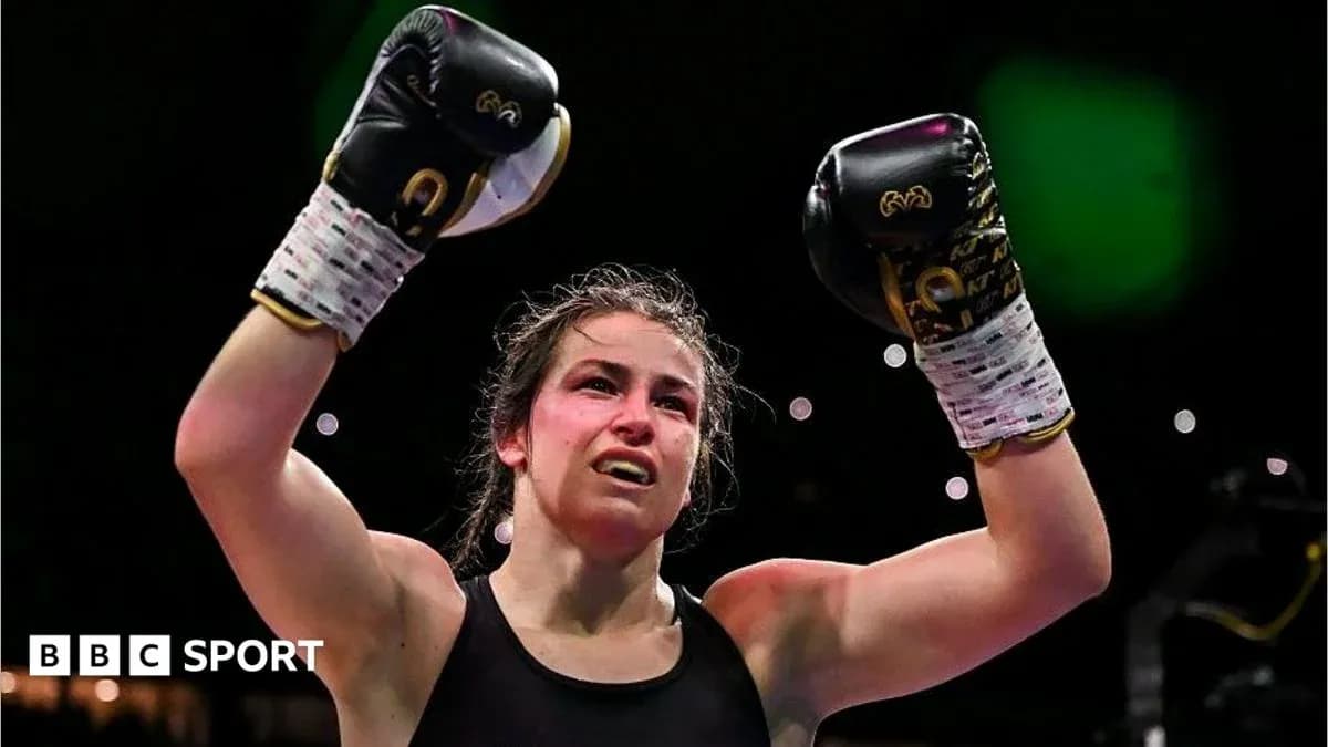 Boxer celebrating victory with raised gloves in ring