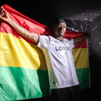 Athlete holding a flag with red, yellow, and green colors