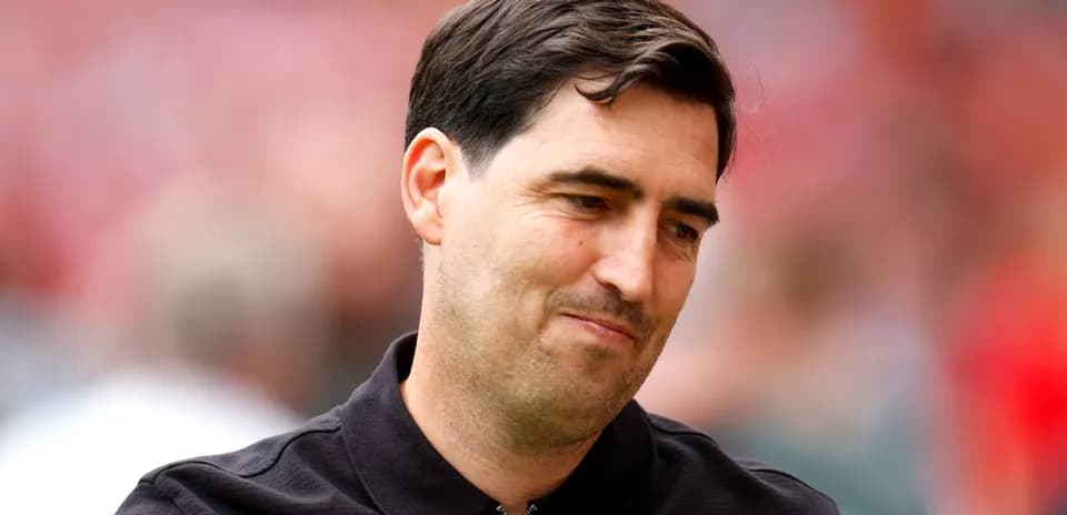 Coach smiling during pre-match warm-up at stadium