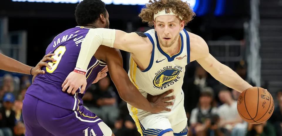 Player dribbling basketball while being guarded