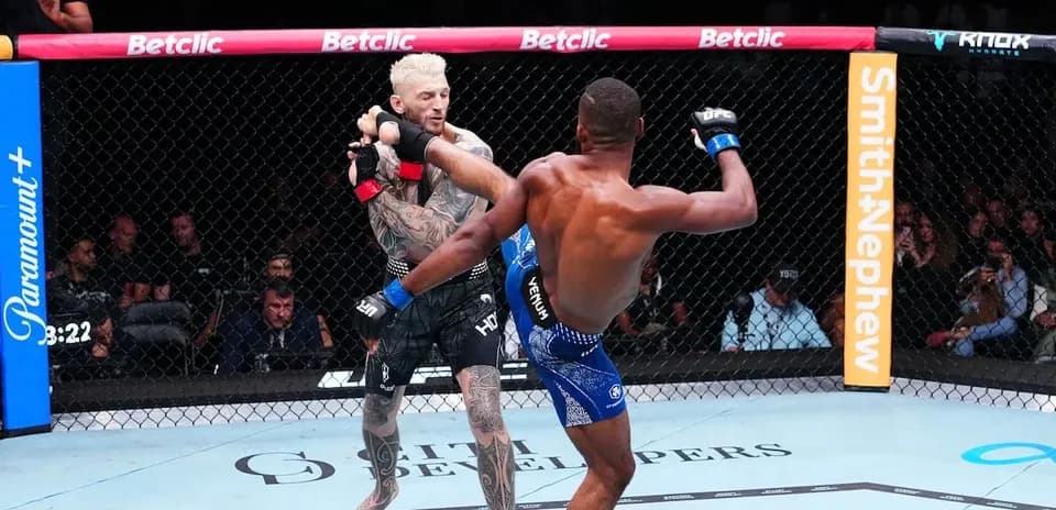 Two fighters engaged in an MMA match inside the octagon