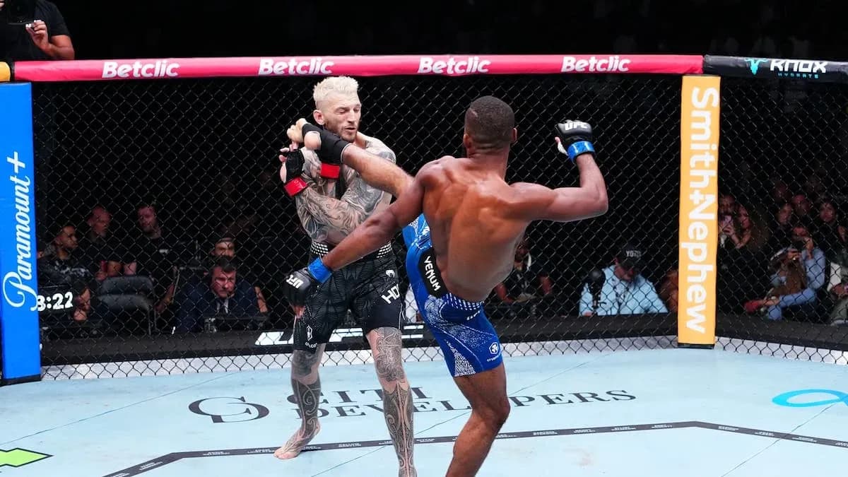 Two fighters engaged in an MMA match inside the octagon