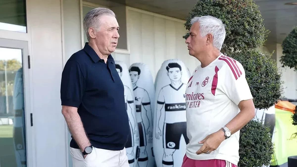 Coaches discussing at training ground with mannequins