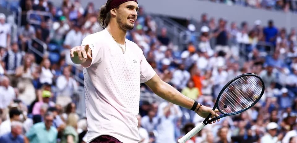 Tennis player gesturing during match with spectators in background