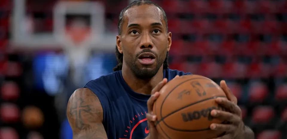 Player practicing shooting with basketball before game