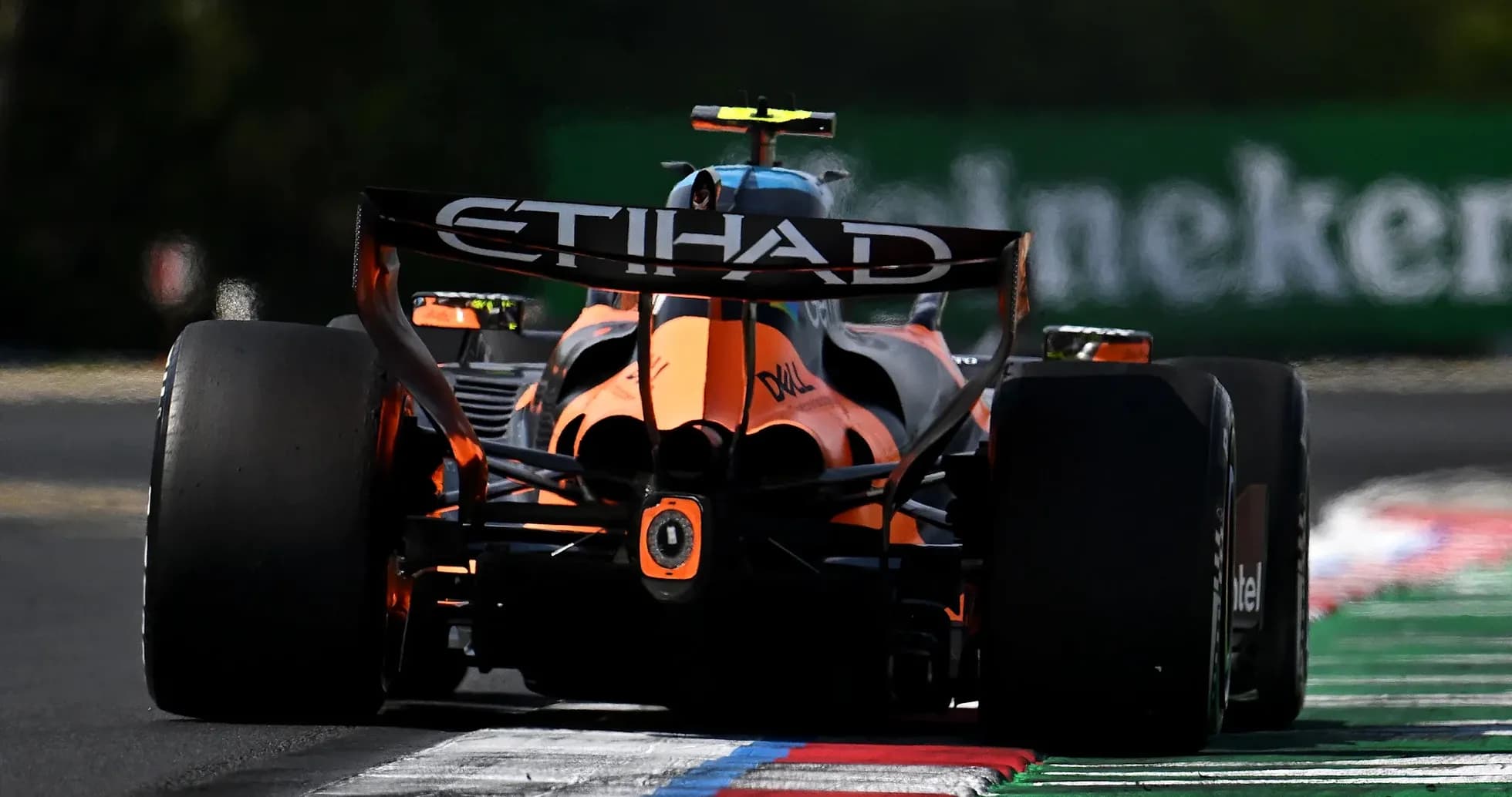 Formula 1 car racing on track with colorful curbs