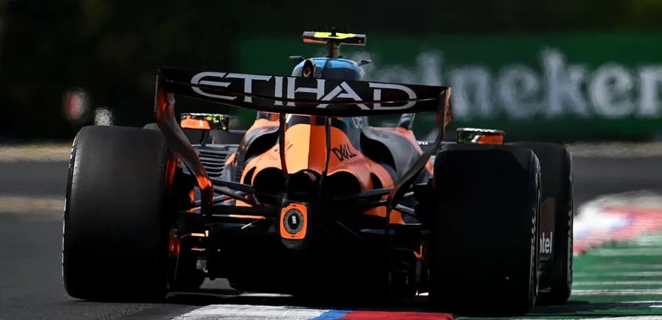 Formula 1 car racing on track with colorful curbs