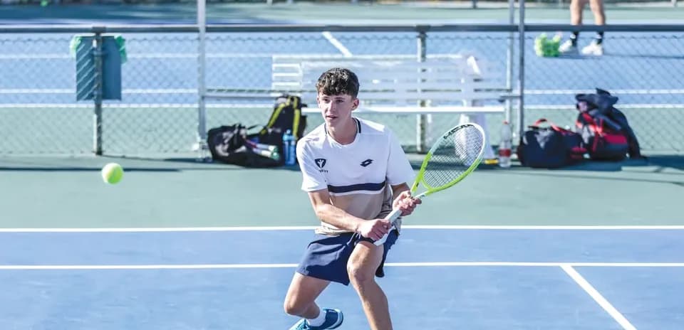 Player preparing to hit a tennis ball on court