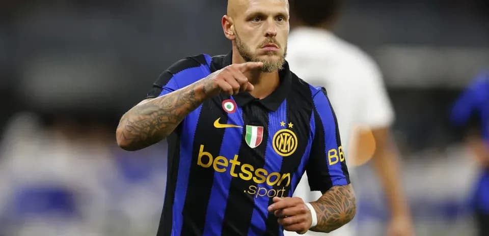 Player pointing during match in blue and black jersey