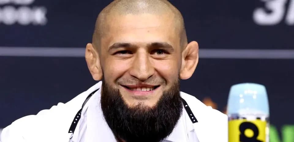 Smiling fighter at press conference with microphone