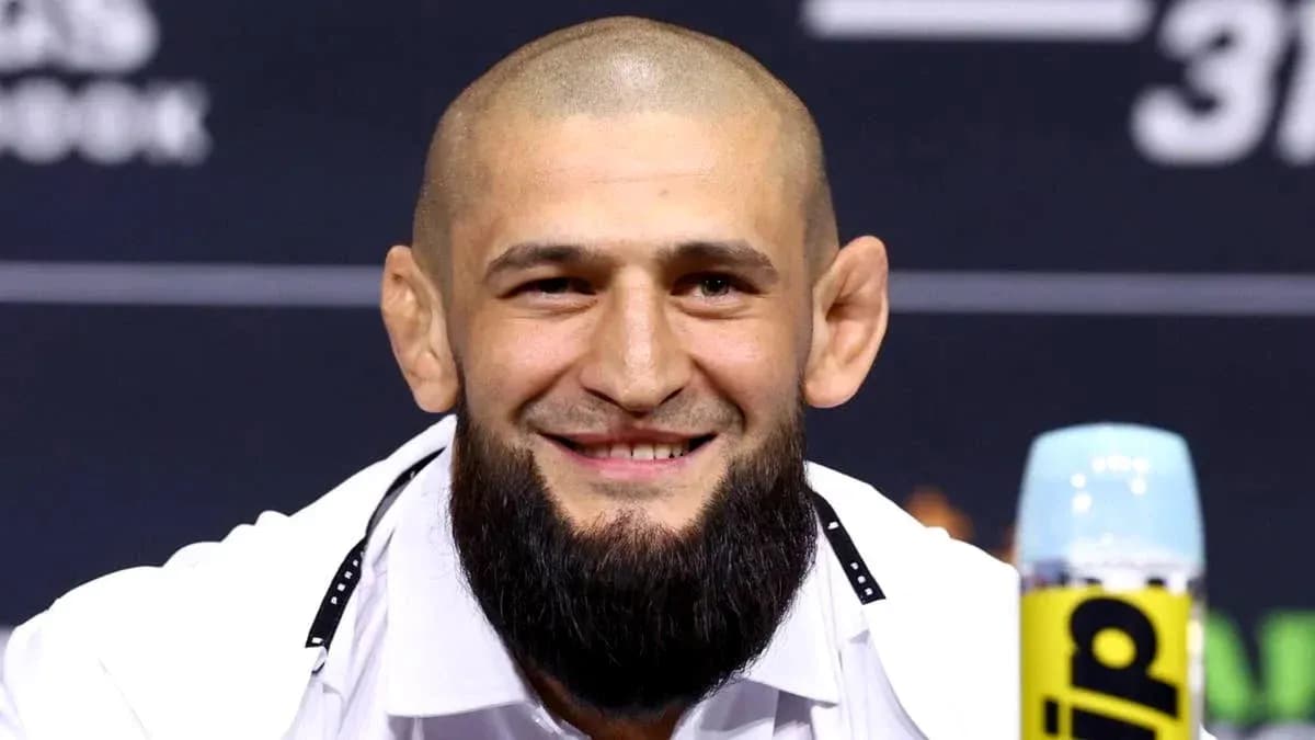 Smiling fighter at press conference with microphone