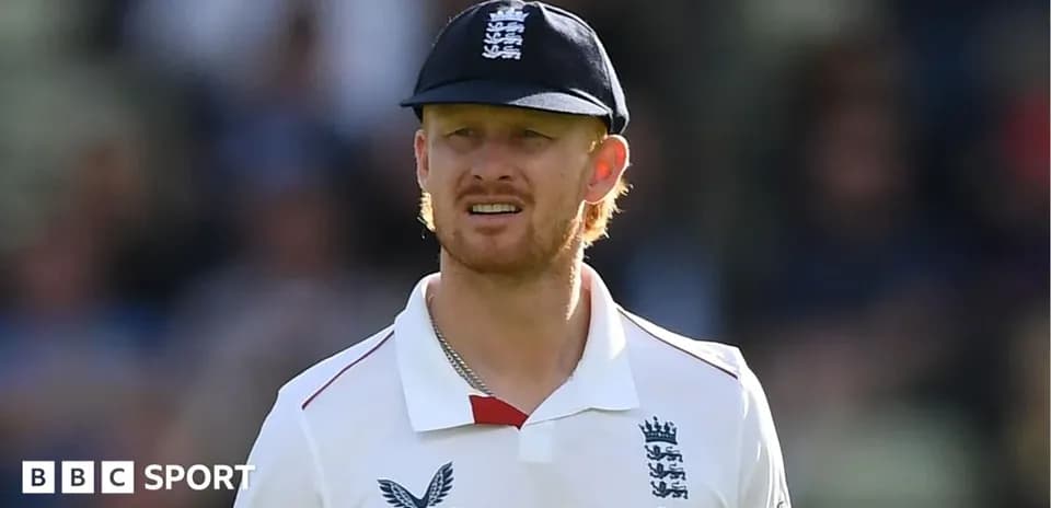 Cricketer wearing England kit on field