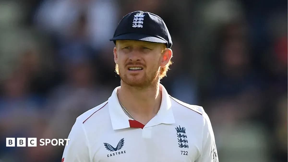 Cricketer wearing England kit on field