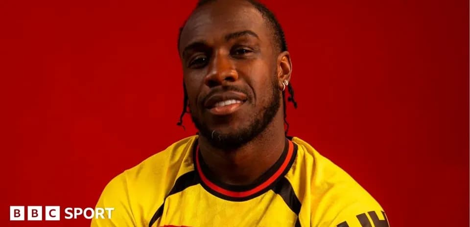 Player in Watford jersey against red background