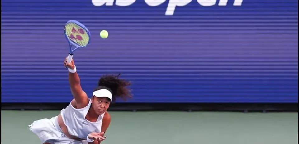 Player serving during US Open tennis match