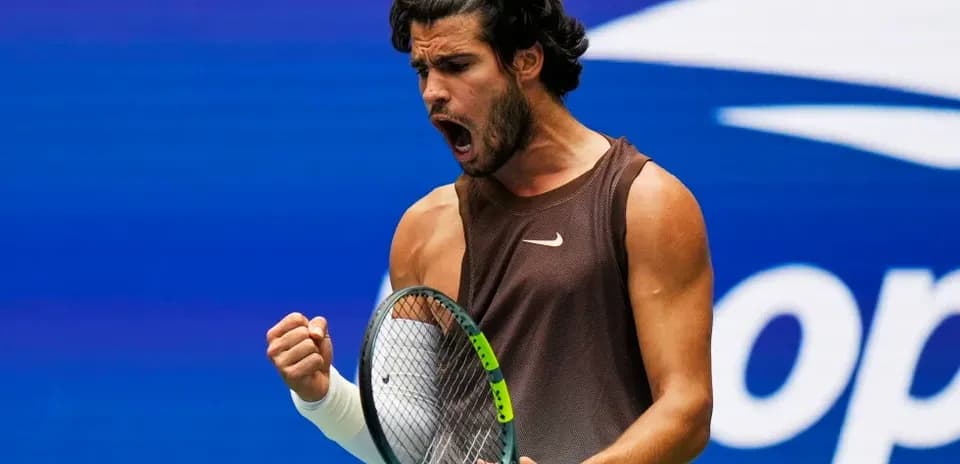 Tennis player celebrating a point on court