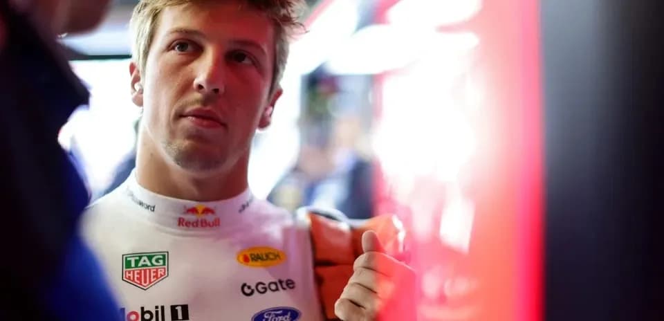 Driver in racing suit preparing for event