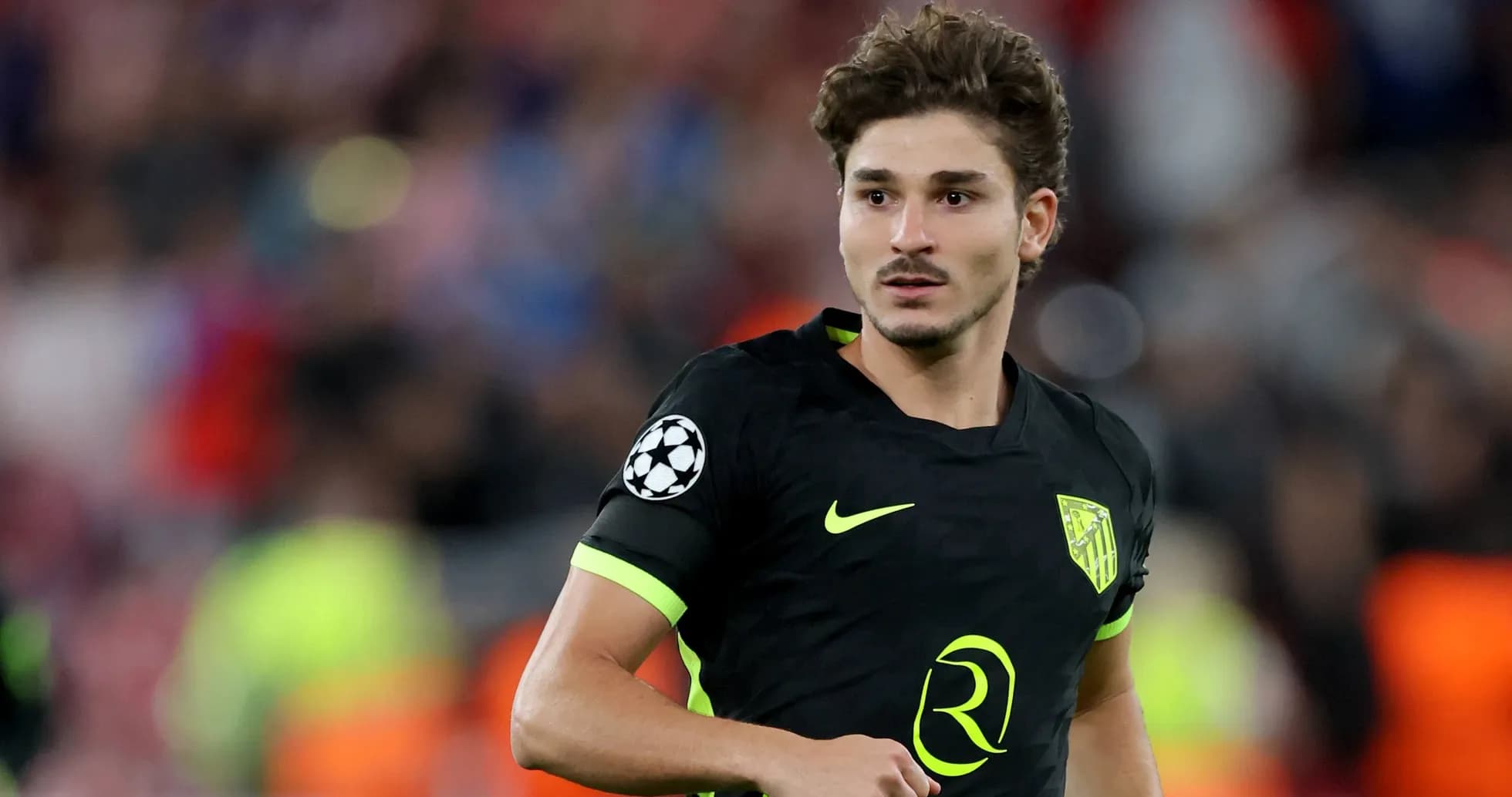 Player in black kit during Champions League match