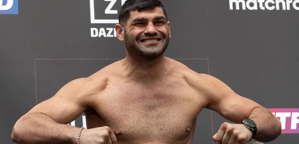 Boxer posing on scale during weigh-in event