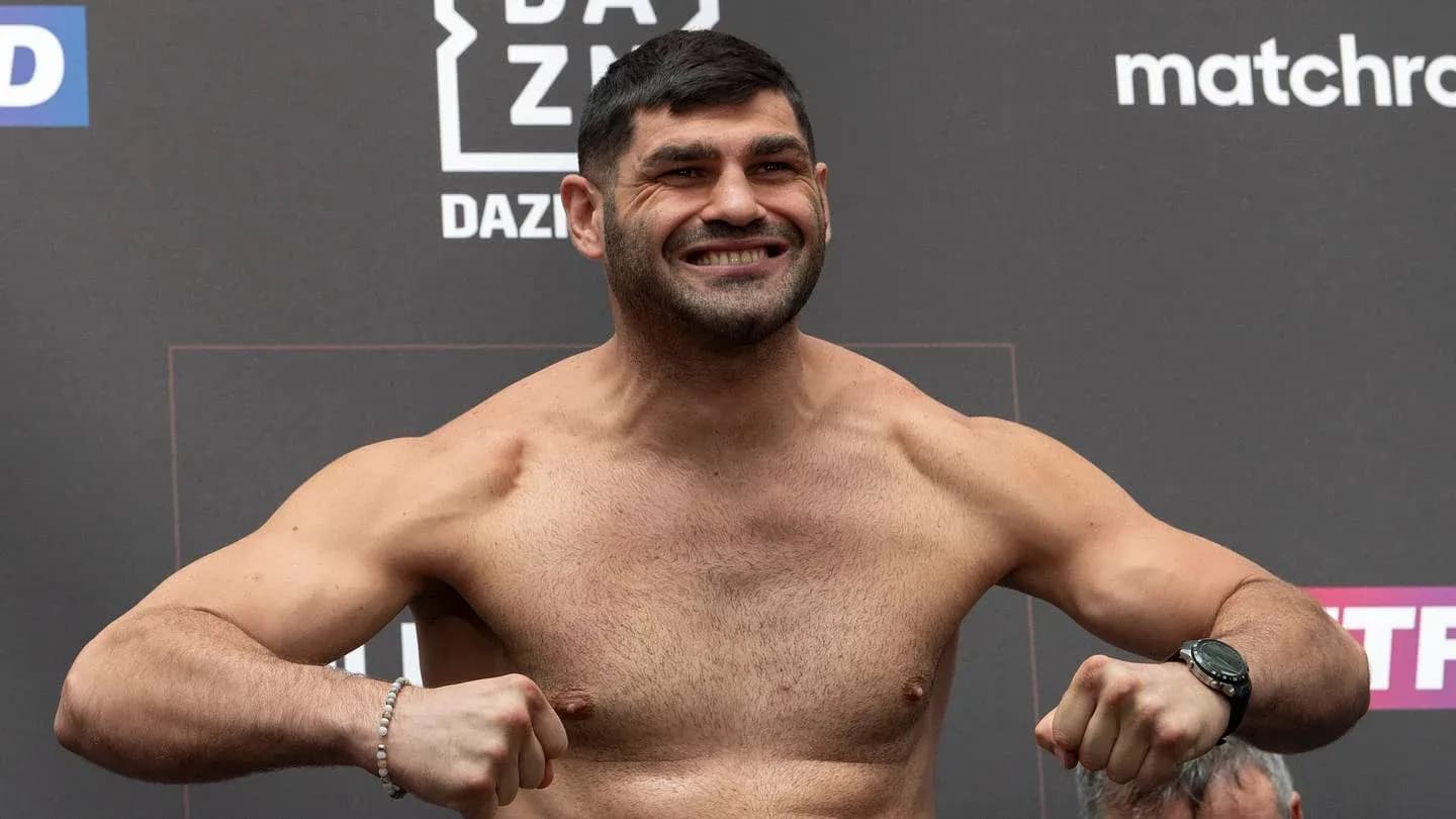 Boxer posing on scale during weigh-in event