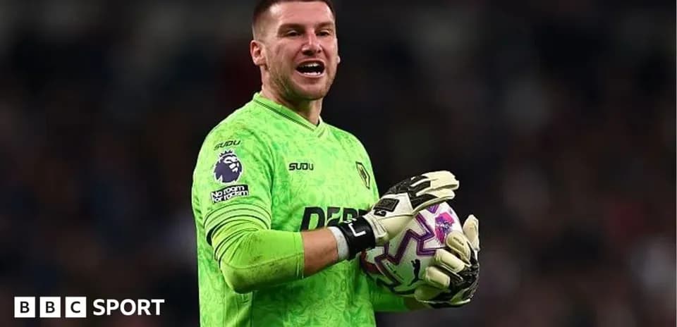 Goalkeeper in green jersey holding a soccer ball