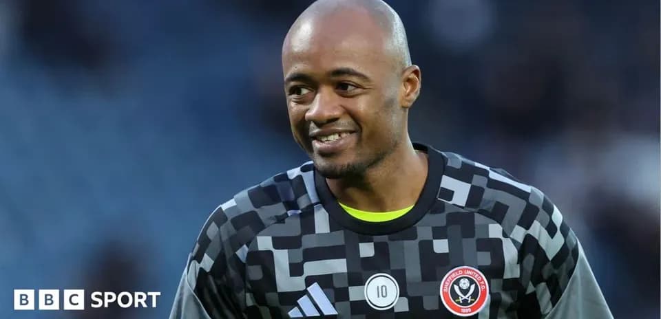 Goalkeeper in uniform smiling during warm-up