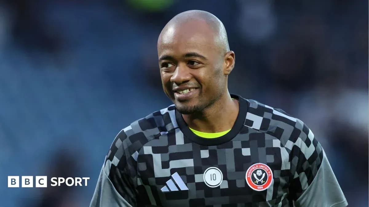 Goalkeeper in uniform smiling during warm-up