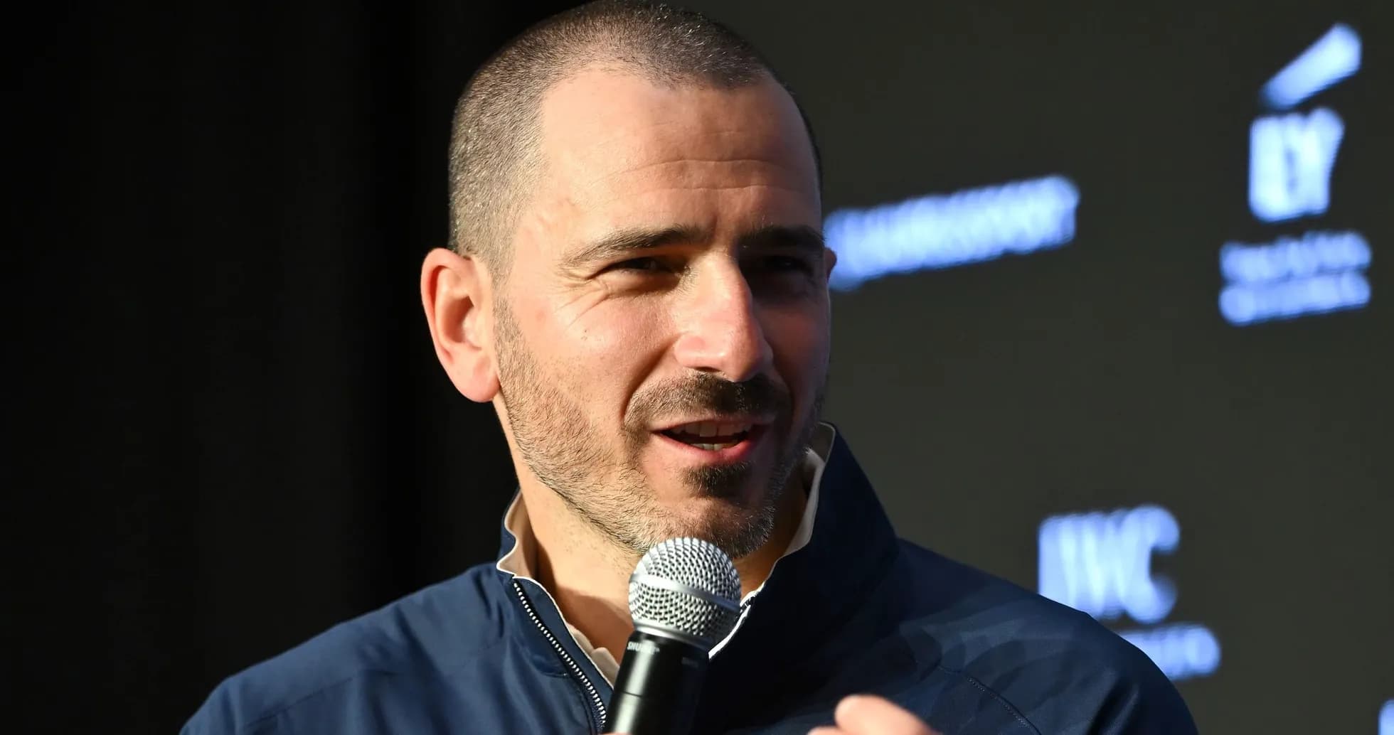 Person speaking into a microphone at event