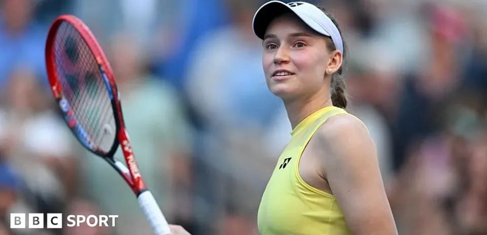 Female tennis player smiling with racket in hand