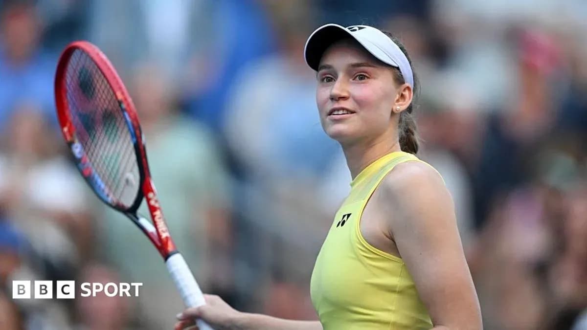 Female tennis player smiling with racket in hand