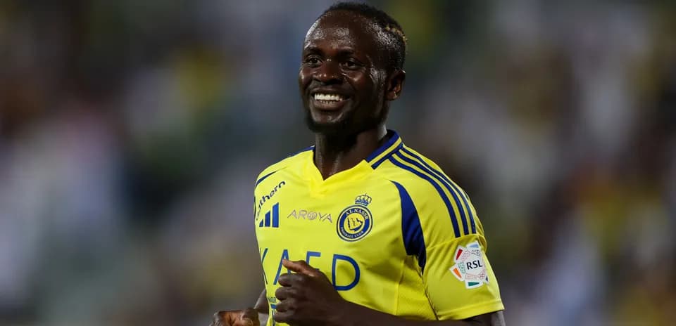 Player smiling in yellow team jersey during match