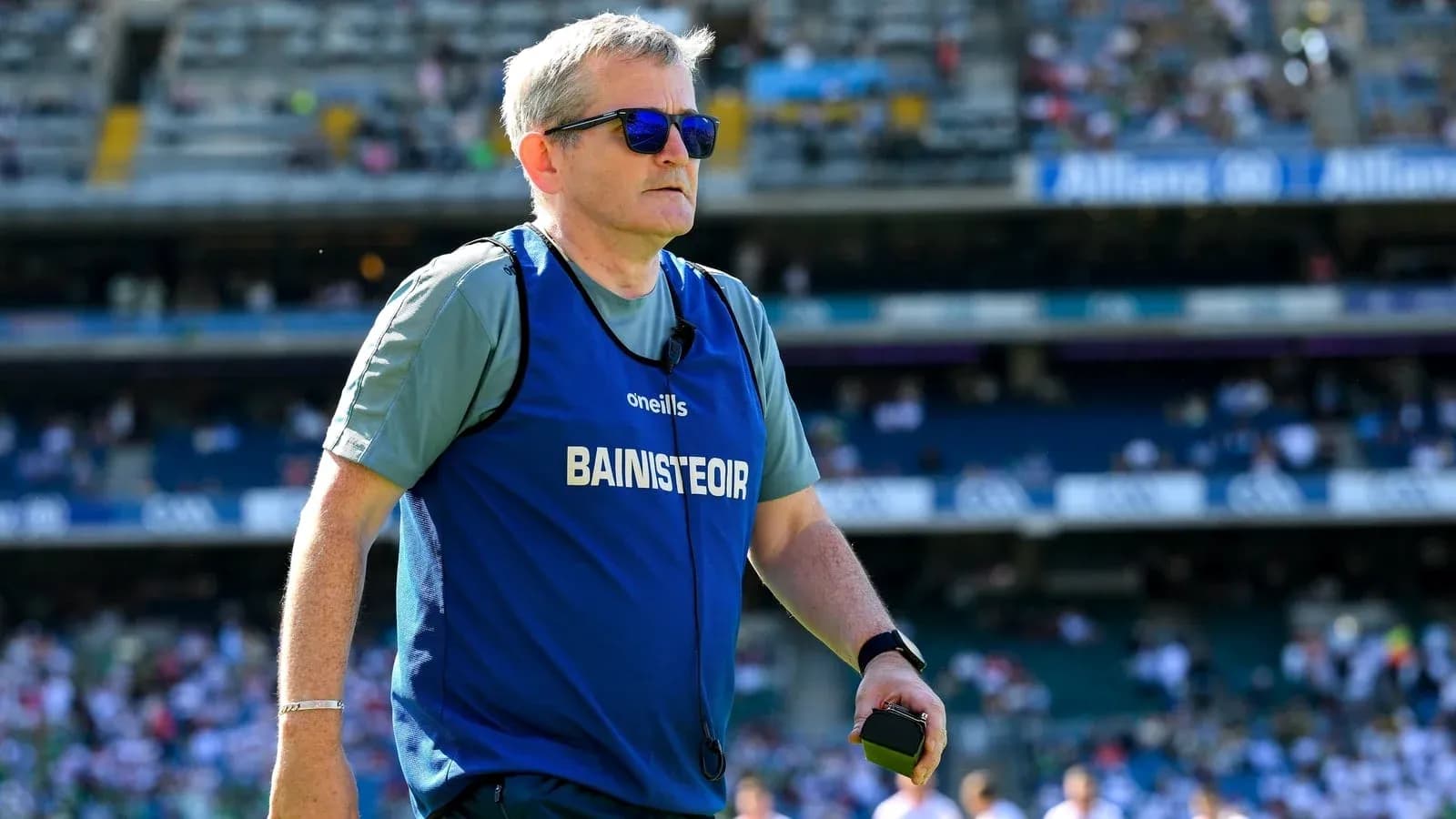Coach wearing sunglasses on the field during match