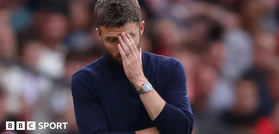 Coach with hand on face during match