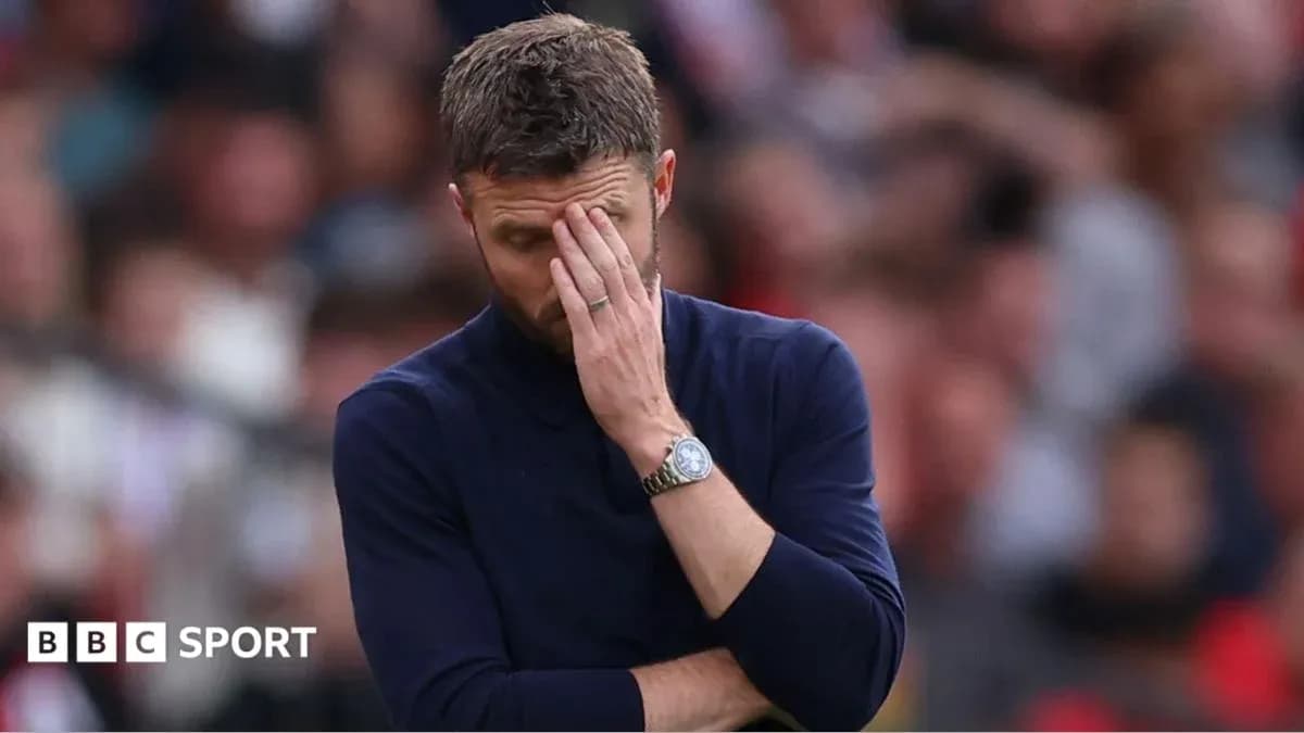 Coach with hand on face during match