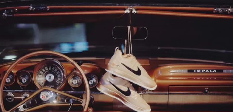 Nike sneakers hanging from car rearview mirror