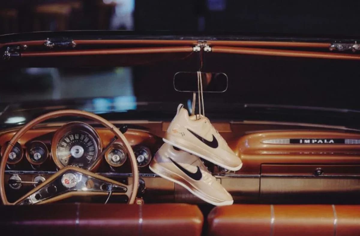 Nike sneakers hanging from car rearview mirror