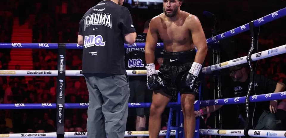 Boxer receiving instructions from coach in corner