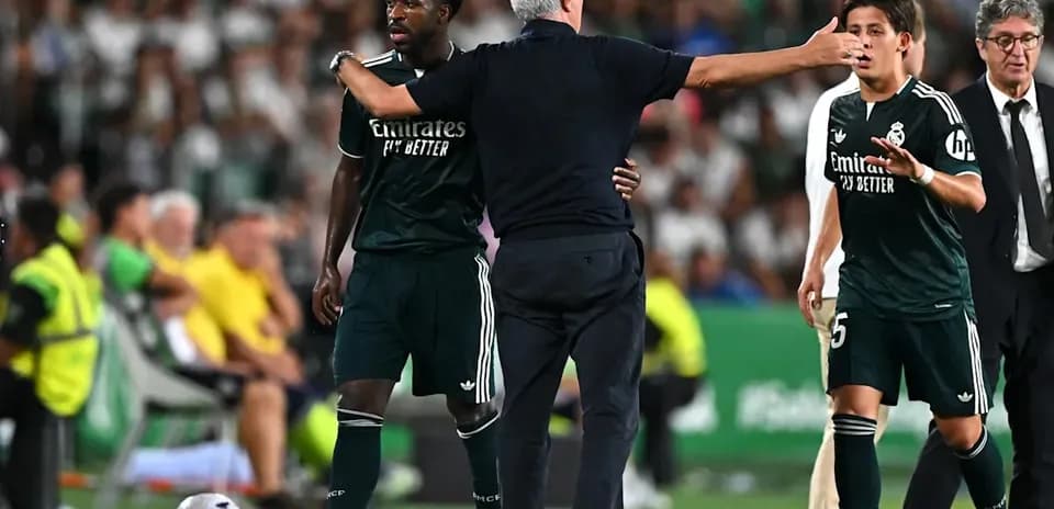 Coach discussing with players on the sidelines