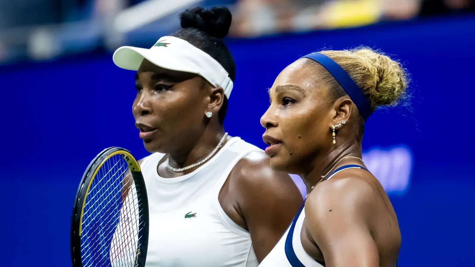 Venus and Serena Williams discussing during match