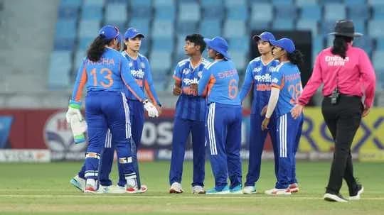 Indian women's cricket team in a huddle on field