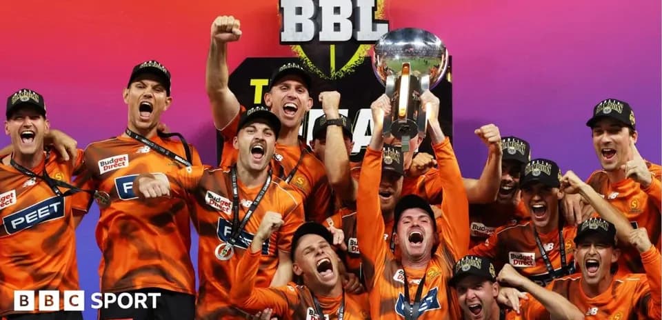 Team celebrating with trophy after championship victory