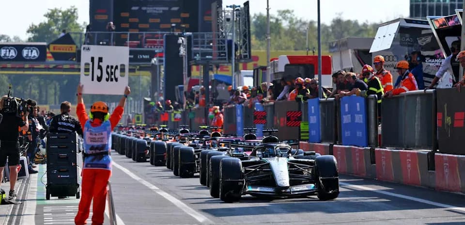Cars lined up in pit lane during Formula 1 event