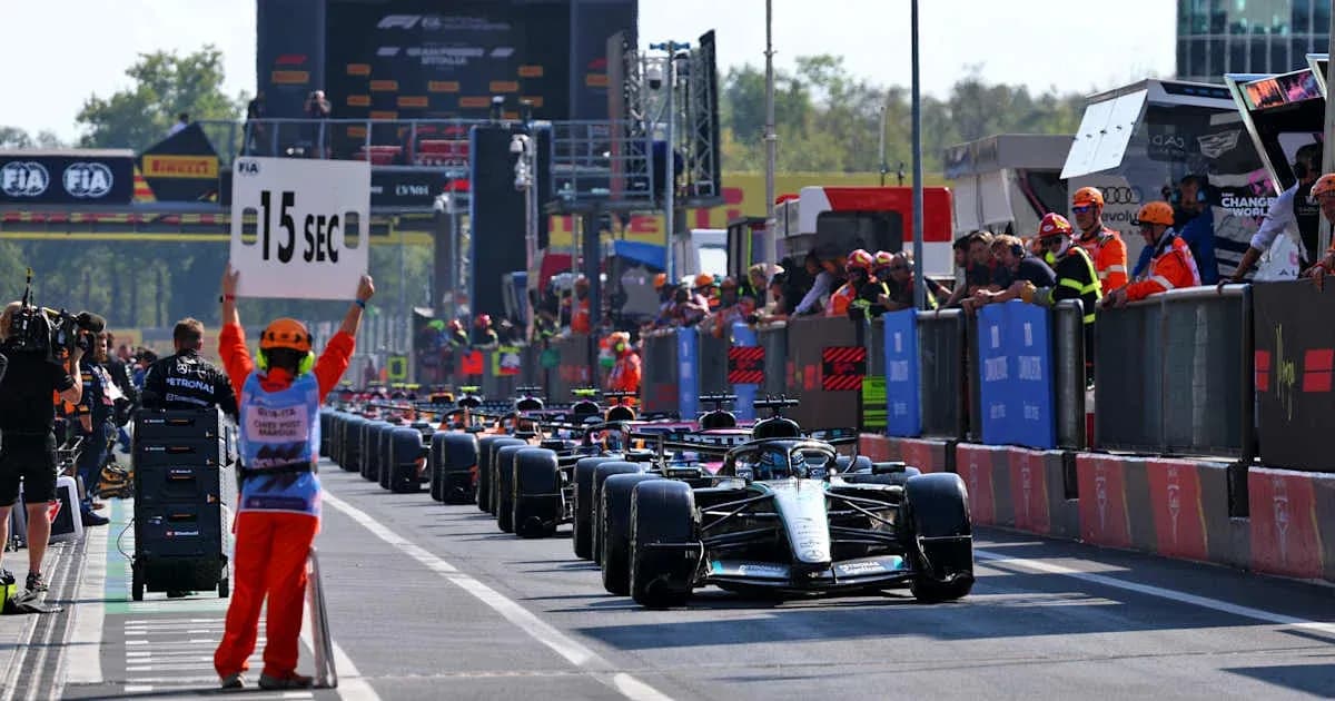 Cars lined up in pit lane during Formula 1 event