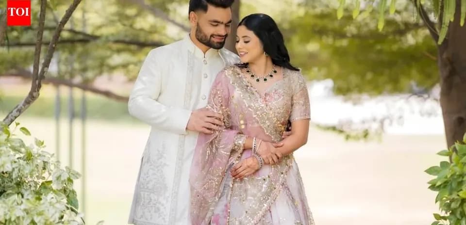 Couple posing together in traditional attire outdoors