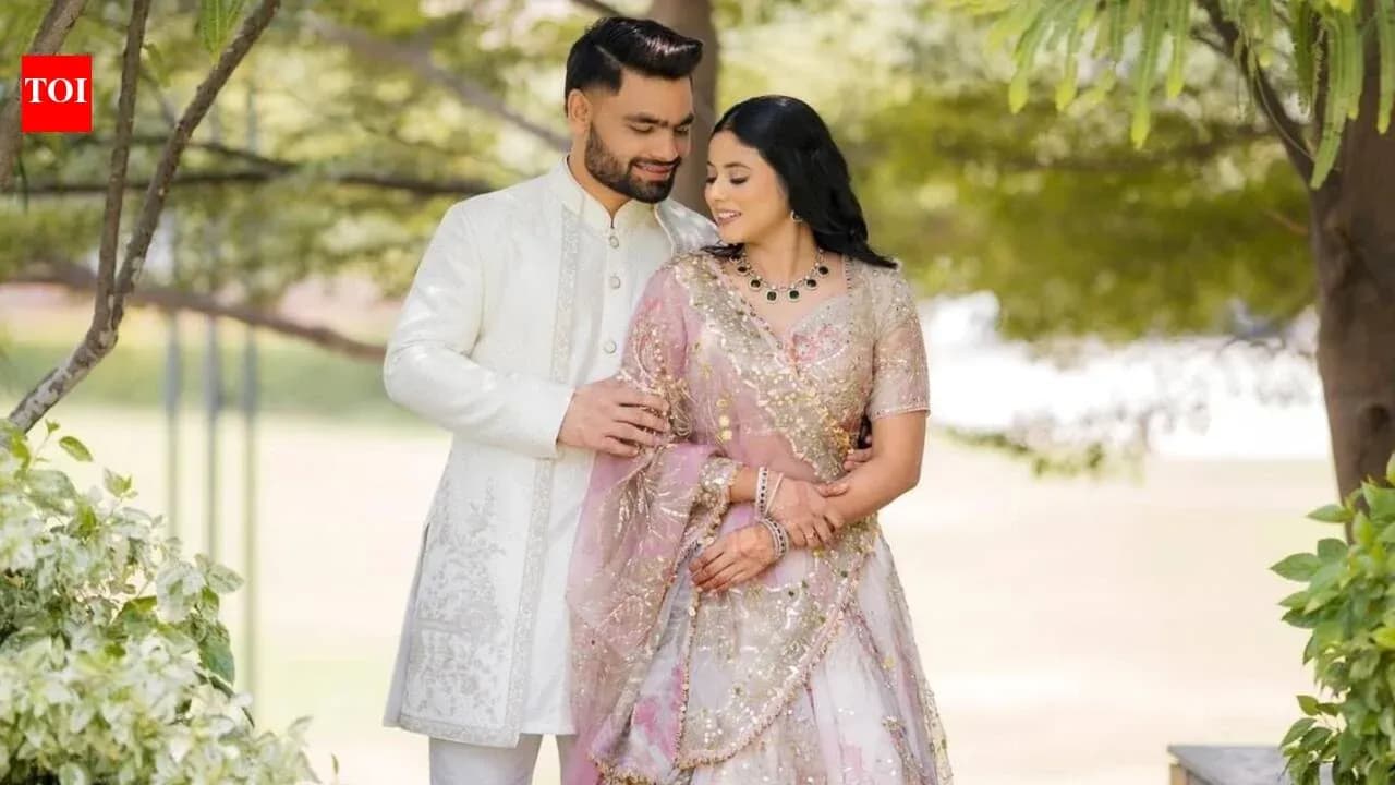 Couple posing together in traditional attire outdoors