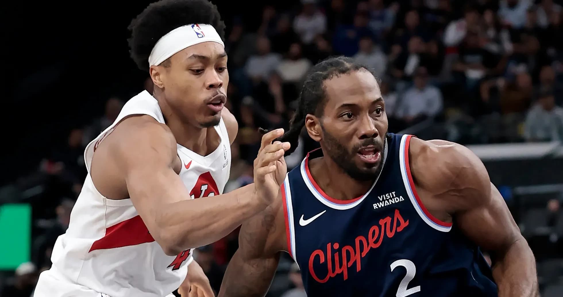 Two basketball players competing for the ball