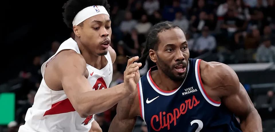 Two basketball players competing for the ball