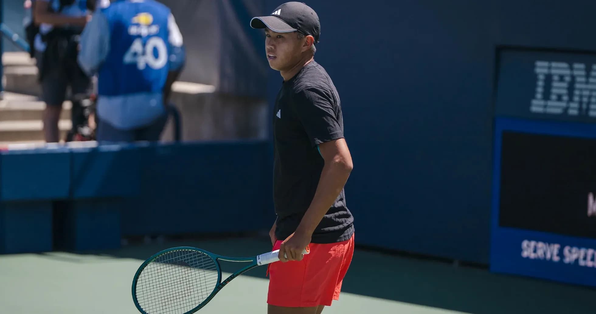 Player preparing to serve during tennis match